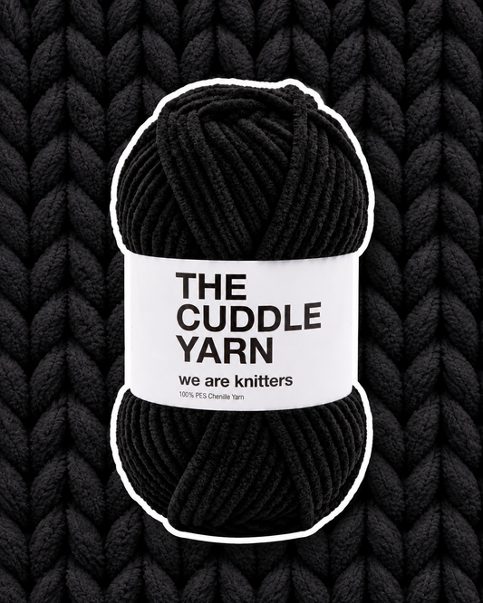The Cuddle Yarn Black skein on matching knit background